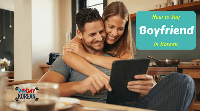 A woman back hugging her boyfriend while they are looking at a tablet