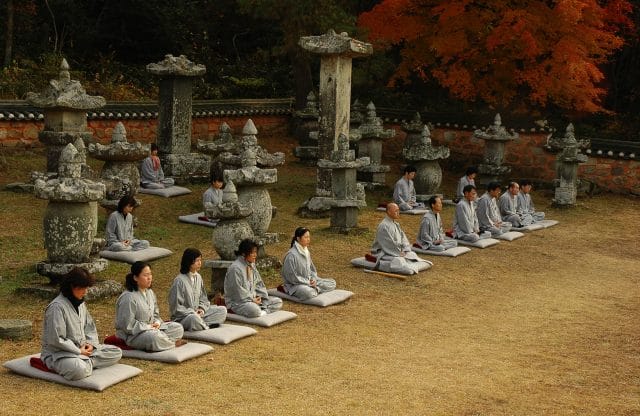 People meditating inside temple grounds