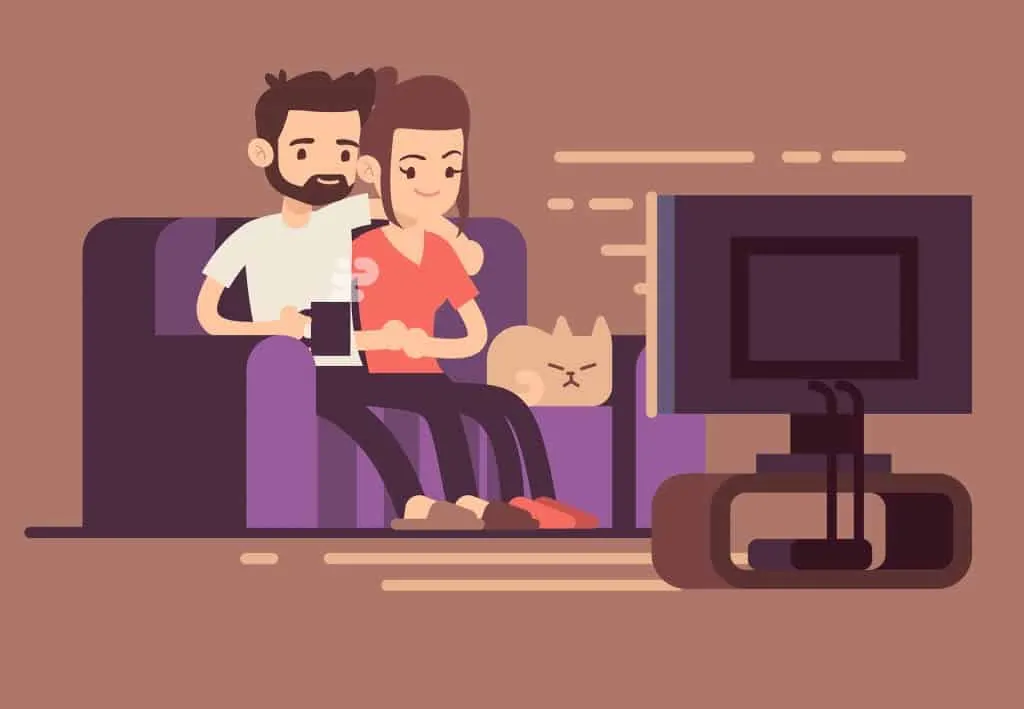 Couple watching TV with a cat sitting on a couch