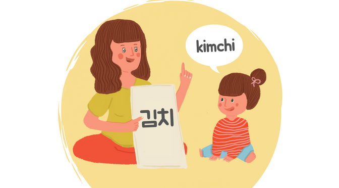 A woman teaching a girl how to say kimchi