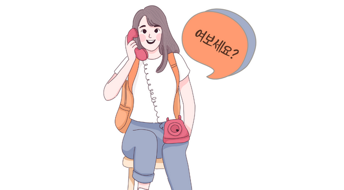 A girl sitting while holding a telephone